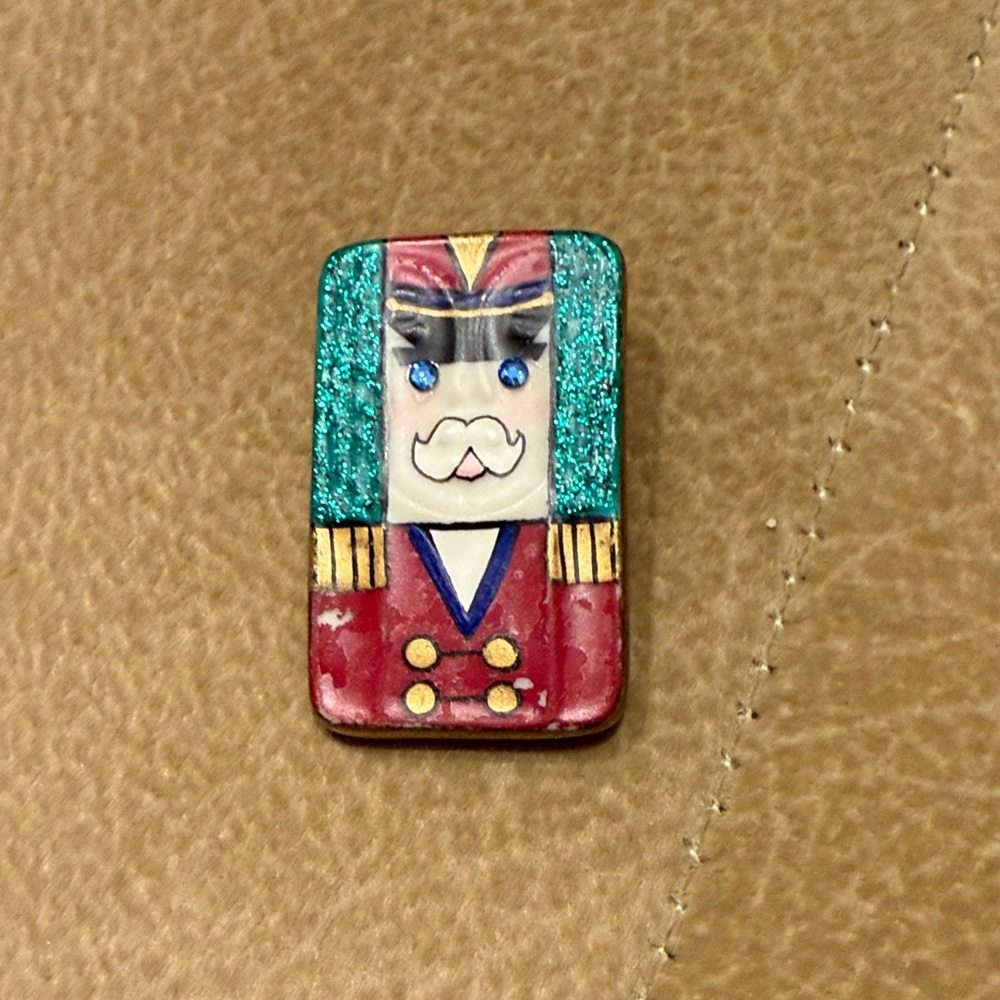 vintage ceramic nutcracker pin. beautiful detail
